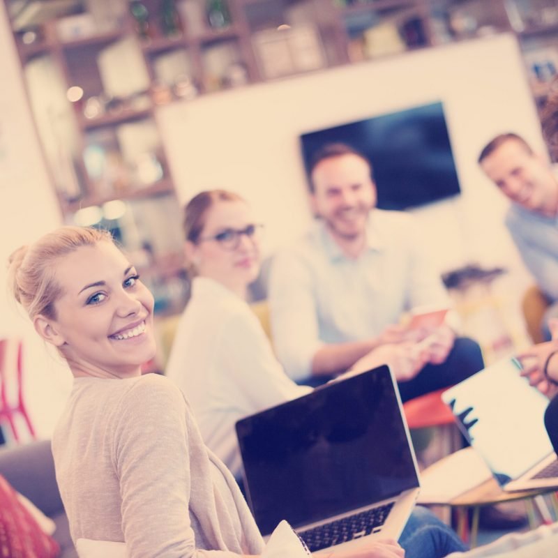 Group of a young business people discussing business plan at modern startup office building